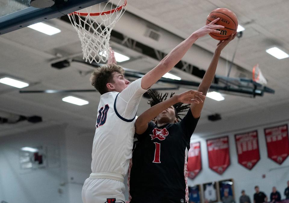Heritage Hills’ Trent Sisley (40) blocks a shot by Princeton’s Edwin Holmes (1) as the Heritage Hills Patriots play the Princeton Tigers at Heritage Hills High School In Lincoln City, Ind., Tuesday, Feb. 20, 2024.