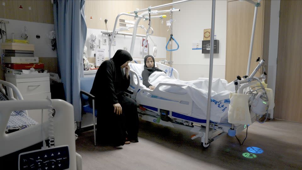 Sabha Al-Soury comforts her daughter Ola at the hospital in Doha. In addition to having lost members of their family, they worry about the fate of those still left behind. - Darren Bull/CNN