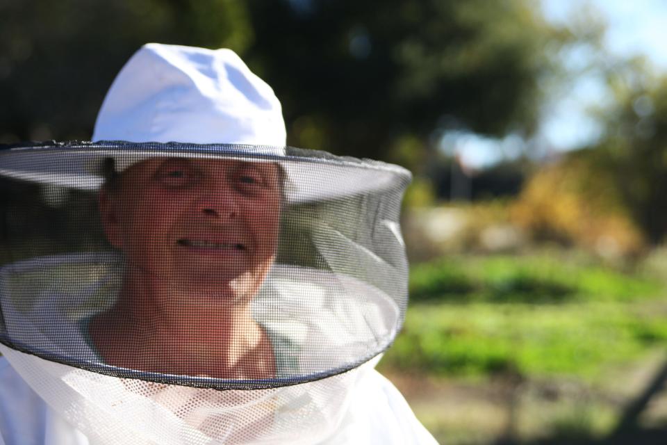 Flora Ripley poses in her beekeeper gear.