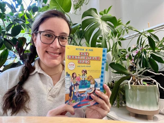 Ariella Borsuk, 39, of Ottawa holds up a copy of The Baby-Sitters Club on Wednesday.