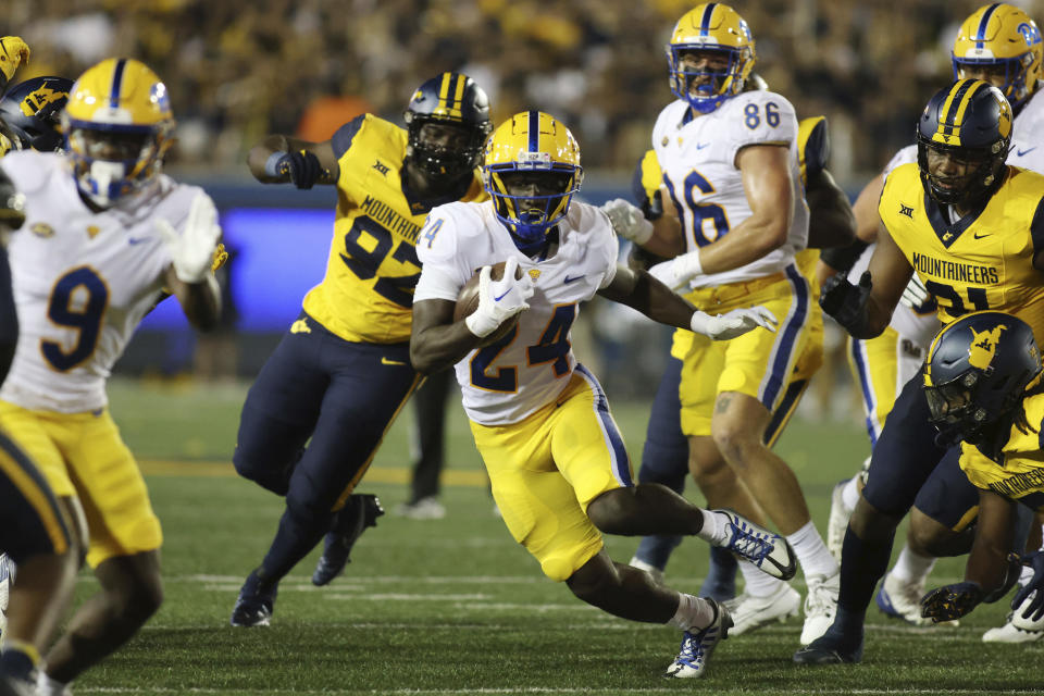 Pittsburgh's C'Bo Flemister (24) carries the ball during the first half of an NCAA college football game against West Virginia, Saturday, Sept. 16, 2023, in Morgantown, W.Va. (AP Photo/Chris Jackson)