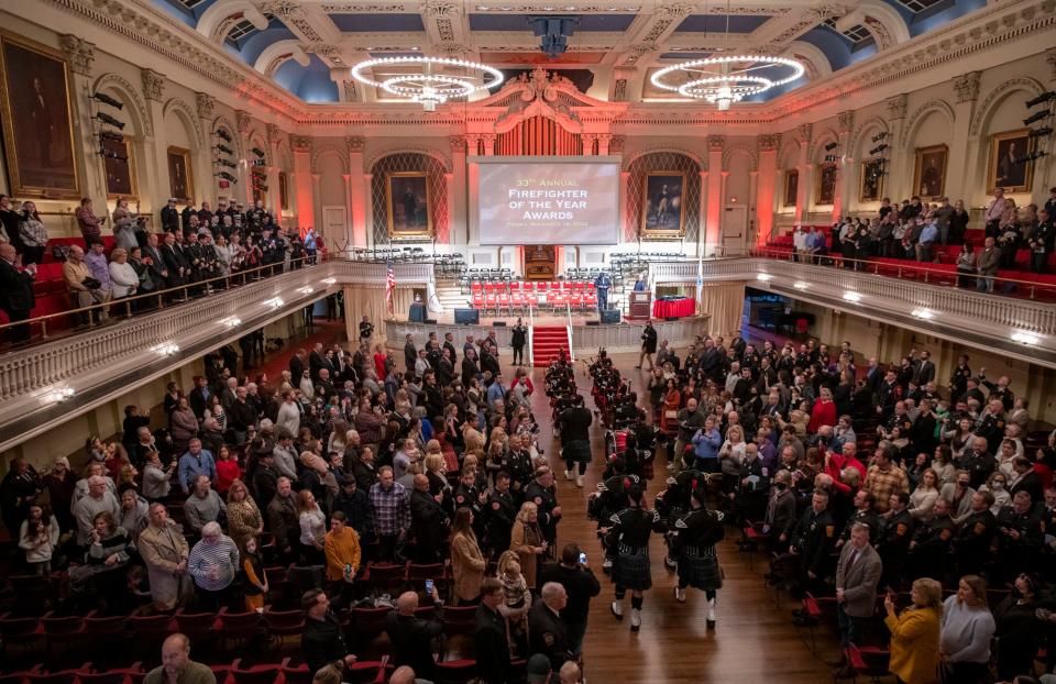 The combined Brockton, Greater Boston and Worcester Firefighter Pipes and Drum Band leads a procession into Mechanics Hall for the  33rd Annual Firefighter of the Year awards ceremony Friday in Worcester.