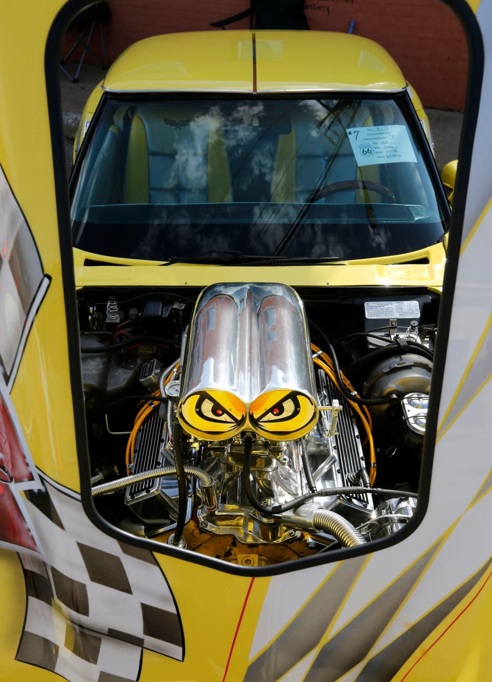 A decorated forced-air charger seems to look out from the engine of a 1978 Corvette during the Bethany 66 Festival in downtown Bethany, Okla. Saturday, May 27, 2017.