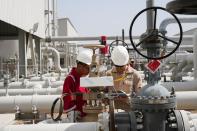 FILE PHOTO: Workers work at Majnoon oil field near Basra