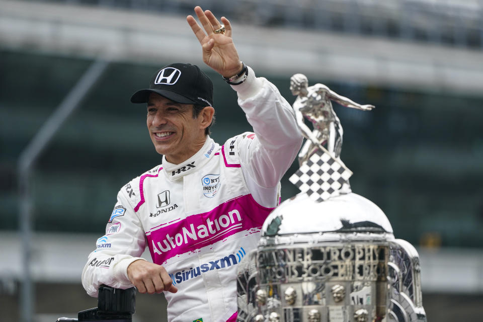 FILE - Helio Castroneves, of Brazil, winner of the 2021 Indianapolis 500 auto race, poses during the traditional winners photo session at the Indianapolis Motor Speedway in Indianapolis, in this Monday, May 31, 2021, file photo. Superstar Racing Experience was conceptualized as a series for former greats who still had the skills and desire to compete and square off in identically prepared cars at six of America’s classic short tracks. Castroneves has no full-time job this season so joining SRX was a no-brainer. (AP Photo/Michael Conroy, File)