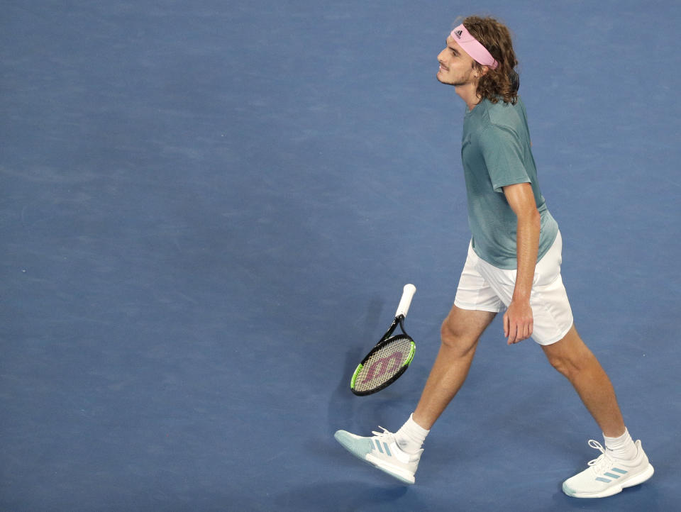 Greece's Stefanos Tsitsipas celebrates after defeating Switzerland's Roger Federer in their fourth round match at the Australian Open tennis championships in Melbourne, Australia, Sunday, Jan. 20, 2019.(AP Photo/Kin Cheung)