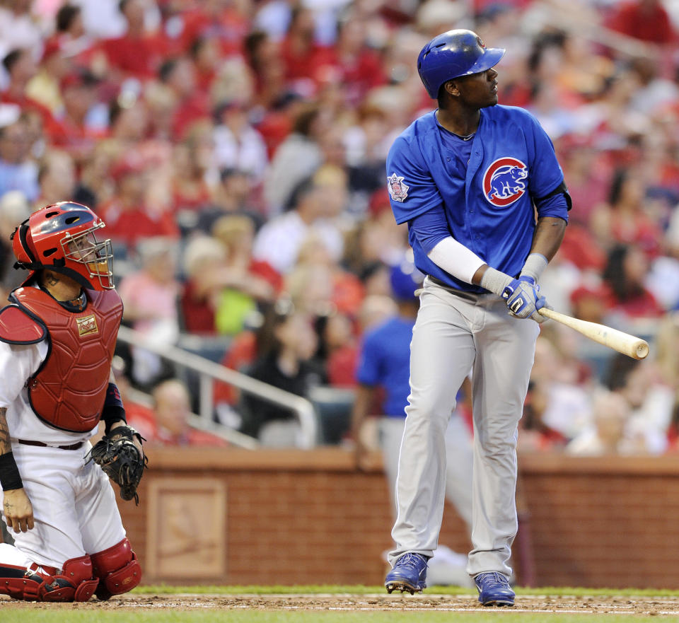 Chicago Cubs' Junior Lake, right, watches his three-run home run as St. Louis Cardinals' Yadier Molina, left, looks on in the second inning in a baseball game, Monday, May 12, 2014, at Busch Stadium in St. Louis. (AP Photo/Bill Boyce)