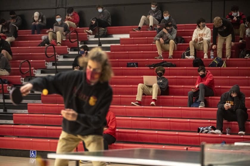 SACRAMENTO, CA - FEBRUARY 24: Students gather in the gym for ping pong and movies while they wait for their Covid testing results at Jesuit High School on Wednesday, Feb. 24, 2021 in Sacramento, CA.. (Brian van der Brug / Los Angeles Times)