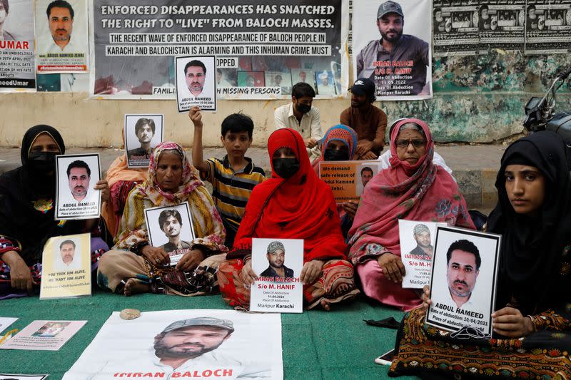 Family members of missing or disappeared persons of the Baloch people hold portraits of their loved ones during a protest in Karachi