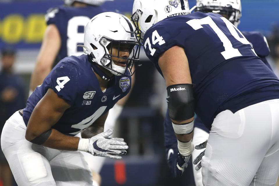 Penn State running back Journey Brown (4) and teammate offensive lineman Steven Gonzalez (74) celebrate after Brown scored a touchdown against Memphis in the first half of the NCAA Cotton Bowl college football game, Saturday, Dec. 28, 2019, in Arlington, Texas. (AP Photo/Ron Jenkins)