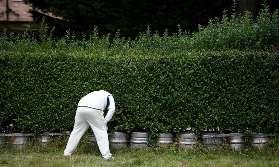 <span>A member of Slough CC searches for a ball at the Indian Gymkhana Cricket Club in July 2020.</span><span>Photograph: Alex Davidson/Getty Images</span>