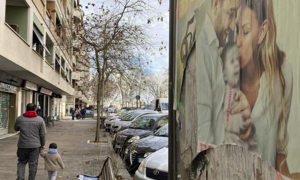 A poster in Rome showing a couple with a baby has ‘extinction’ written across it.