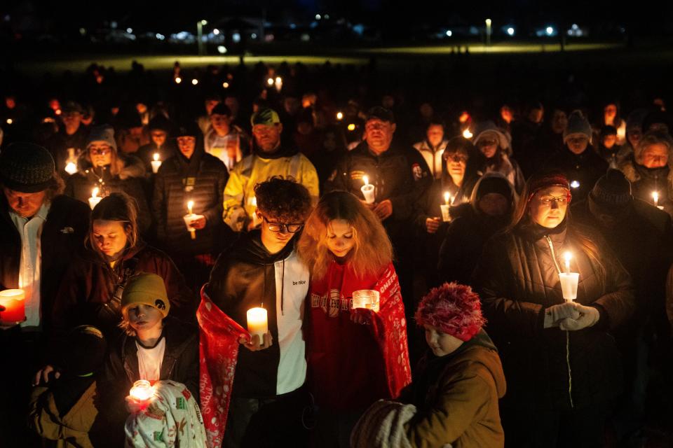 Community members gather as they honor the victims of a shooting at Perry High School Thursday, Jan. 4, 2024, at Wiese Park in Perry.