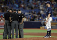 Tampa Bay Rays relief pitcher Adam Kolarek waits as umpire confer during the eighth inning of a baseball game against the Boston Red Sox Wednesday, July 24, 2019, in St. Petersburg, Fla. Kalrek was pitching, then moved to first base, and then back to pitcher in the inning. (AP Photo/Chris O'Meara)