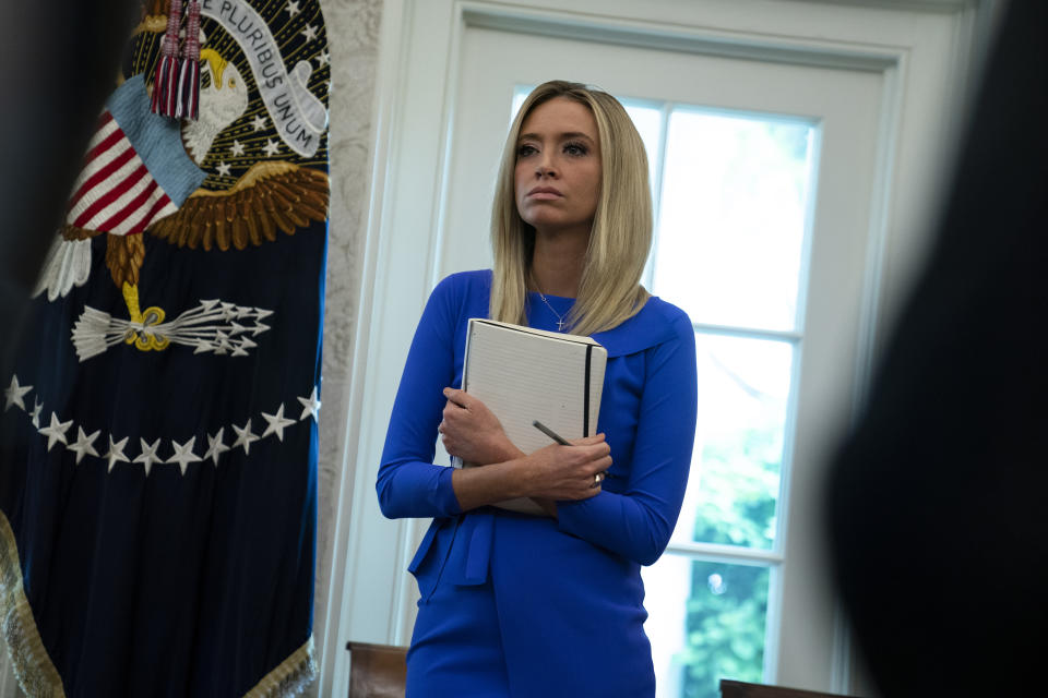 White House press secretary Kayleigh McEnany listens during a meeting between President Donald Trump and Gov. Ron DeSantis, R-Fla., about the coronavirus response, in the Oval Office of the White House, Tuesday, April 28, 2020, in Washington. (AP Photo/Evan Vucci)