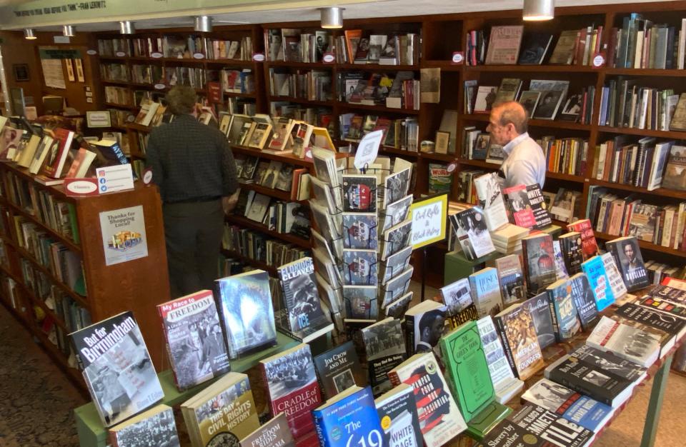 NewSouth Bookstore co-owner Randall Williams speaks with a customer in the store's front area.