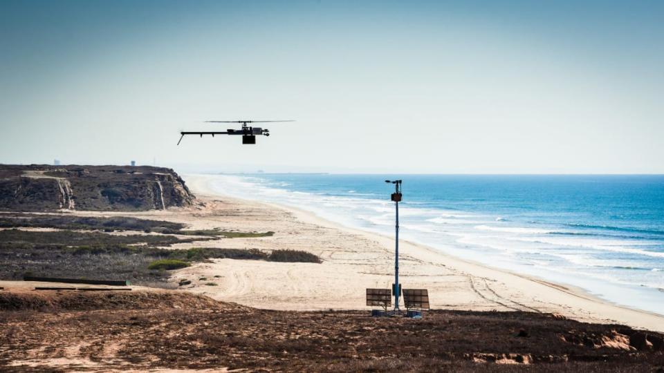 <div class="inline-image__caption"><p>An Anduril sentry tower with one of the company's heli-drones</p></div> <div class="inline-image__credit">Anduril</div>