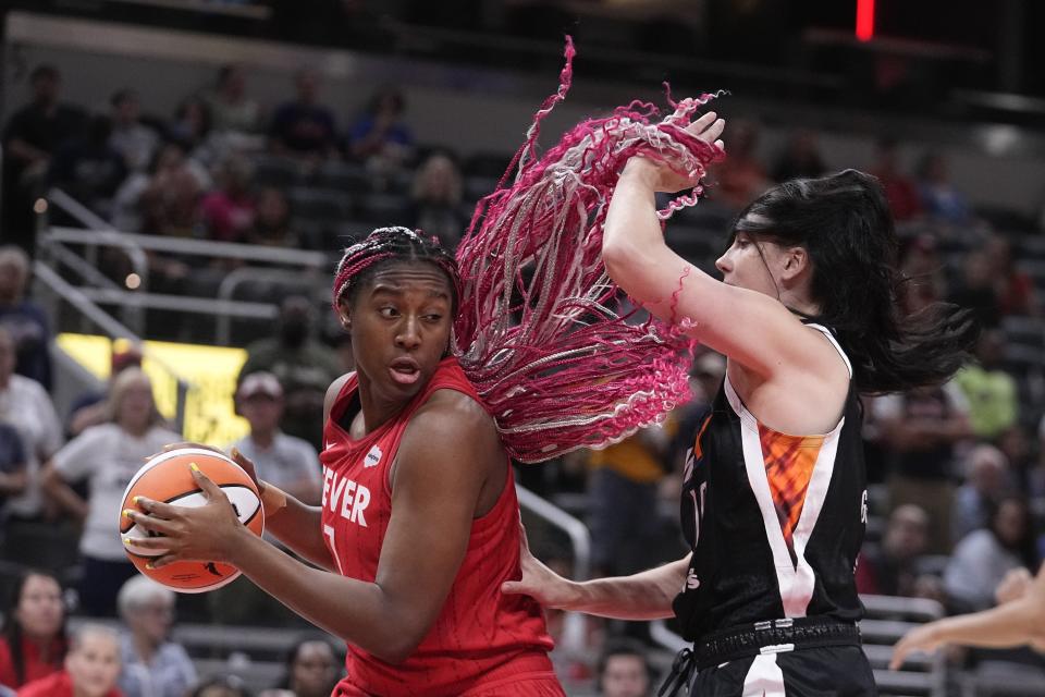 Indiana Fever's Aliyah Boston (7) goes to the basket against Phoenix Mercury's Megan Gustafson during the first half of a WNBA basketball game, Tuesday, Aug. 1, 2023, in Indianapolis. (AP Photo/Darron Cummings)