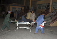 An injured man is transported to a hospital after a bombing in Mazar-e-Sharif, northern Afghanistan, Wednesday, May 25, 2022. A series of explosions shook Afghanistan on Wednesday, the Taliban said, including a blast inside a mosque in the capital of Kabul that killed at least five worshippers and three bombings of minivans in the country's north that killed nine passengers. (AP Photo/Masih Paeiz)