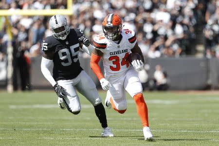 Sep 30, 2018; Oakland, CA, USA; Cleveland Browns running back Carlos Hyde (34) runs the ball against the Oakland Raiders in the first quarter at Oakland Coliseum. Mandatory Credit: Cary Edmondson-USA TODAY Sports