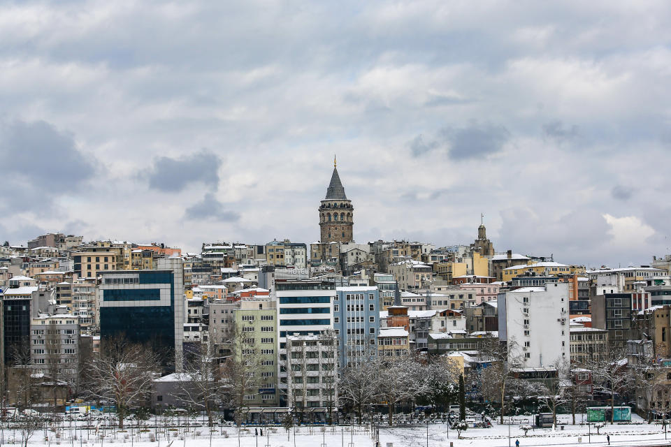 The city's Golden Horn area with Galata Tower in the background at Istanbul, Tuesday, Jan. 25, 2022. Rescue crews in Istanbul and Athens on Tuesday cleared roads that had come to a standstill after a massive cold front and snowstorms hit much of Turkey and Greece, leaving countless people and vehicles in both cities stranded overnight in freezing conditions.(AP Photo/Emrah Gurel)