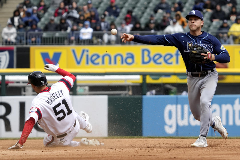 Tampa Bay Rays shortstop Taylor Walls, right, throws out Chicago White Sox's Andrew Vaughn at first after forcing out Adam Haseley at second during the third inning of a baseball game in Chicago, Sunday, April 30, 2023. (AP Photo/Nam Y. Huh)