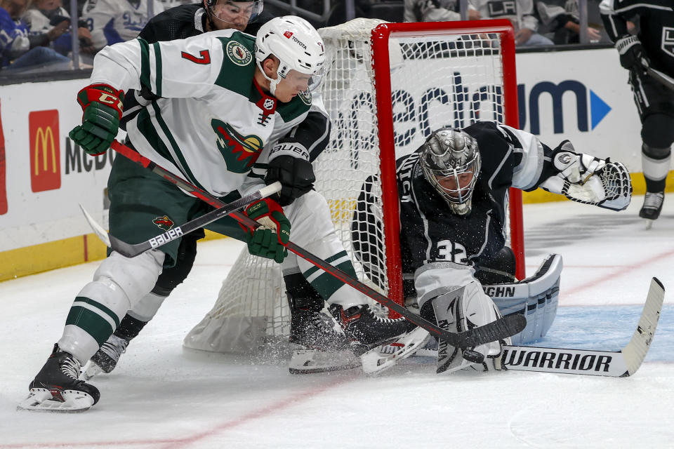 Los Angeles Kings goalie Jonathan Quick (32) blocks a shot by Minnesota Wild forward Nico Sturm (7) during the second period of an NHL hockey game Saturday, Oct. 16, 2021, in Los Angeles. (AP Photo/Ringo H.W. Chiu)
