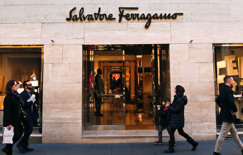 FILE PHOTO: People walks past a Salvatore Ferragamo shop in downtown Rome