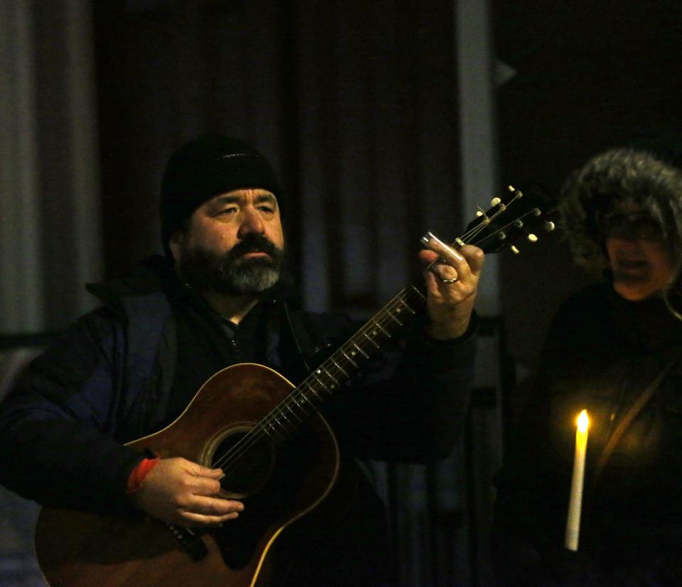 Musician Jon Nolan plays during the Homeless Persons' Memorial Day vigil in downtown Portsmouth Thursday, Dec. 21, 2023.