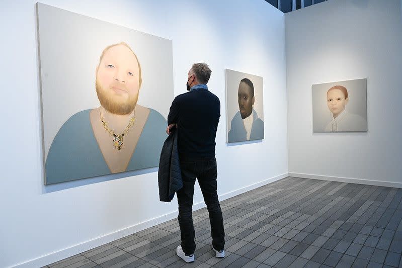 <p>We were taken by the luminous, large-scale portraiture of the Yorkshire, England–born painter Sarah Ball. The artist selects her subjects through found images from newspapers, magazines, and social media, but unlike Richard Prince and his famously <a href="http://vulture.com/2014/09/richard-prince-instagram-pervert-troll-genius.html" rel="nofollow noopener" target="_blank" data-ylk="slk:troll-y Instagram paintings;elm:context_link;itc:0;sec:content-canvas" class="link ">troll-y Instagram paintings</a>, Ball approaches her subjects with a tender intimacy. Large swaths of her images (namely backdrops and clothing) are rendered nearly flat in favor of evocative details like a stud earring, a necklace, and—most of all—the anonymous sitters’ eyes. </p>