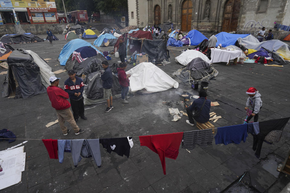 Migrants camp in tents outside the Church of Santa Cruz y La Soledad in Mexico City, Tuesday, Dec. 26, 2023. (AP Photo/Marco Ugarte)