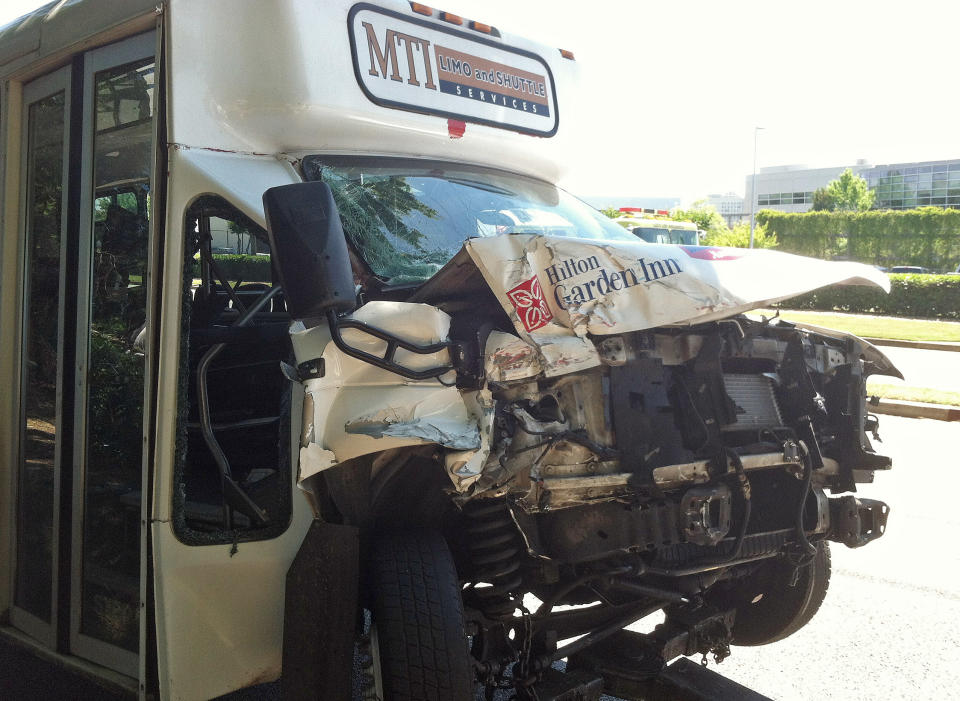 A wrecked airport shuttle bus is shown Friday, May 24, 2013 in College Park, Ga.. The bus collided with a truck near Hartsfield Jackson Atlanta International Airport injuring 16 people who were taken to area hospitals. (AP Photo/Ray Henry)