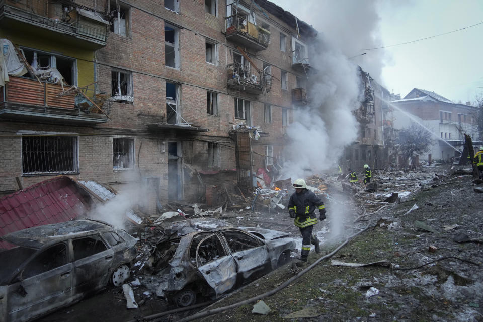 Ukrainian State Emergency Service firefighters work to extinguish a fire at the scene of a Russian shelling in the town of Vyshgorod outside the capital Kyiv, Ukraine, Wednesday, Nov. 23, 2022. Authorities reported power outages in multiple cities of Ukraine, including parts of Kyiv, and in neighboring Moldova after renewed strikes Wednesday struck Ukrainian infrastructure facilities. (AP Photo/Efrem Lukatsky)