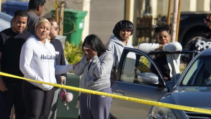 Neighbors react near the Lancaster home where five family members found with gunshot wounds were pronounced dead at the scene by summoned paramedics. (Photo: Ringo H.W. Chiu/AP)