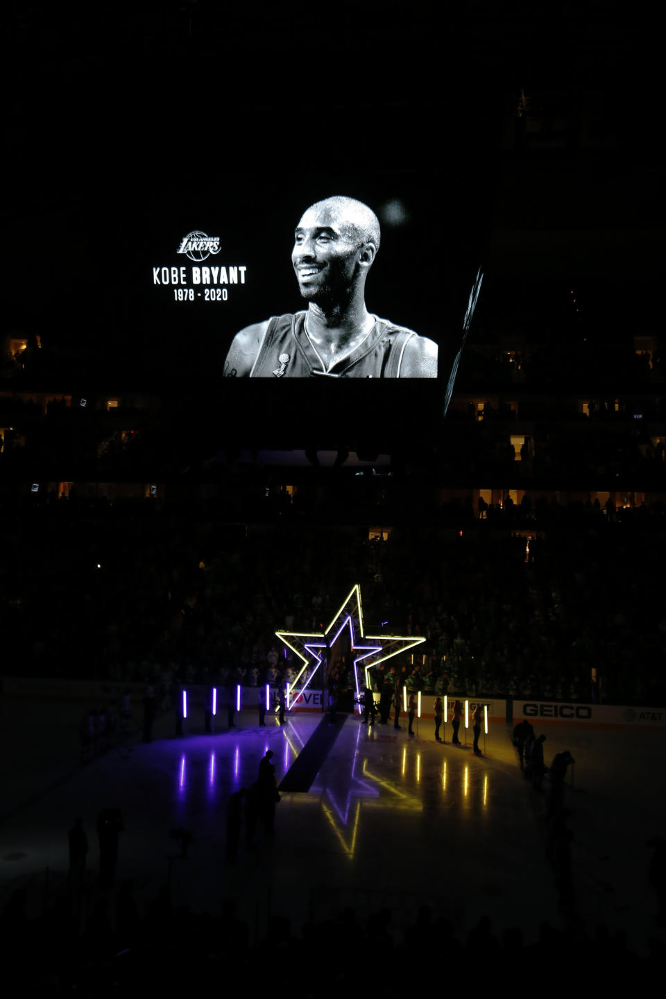 Fans honor the memory of Kobe Bryant with a moment of silence before an NHL hockey game between the Dallas Stars and the Tampa Bay Lightning in Dallas, Monday, Jan. 27, 2020. (AP Photo/Ray Carlin)