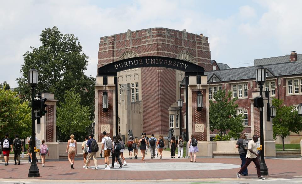 Students walk through Purdue University's archway on the first day of the 2023-2024 academic school year, on Monday, Aug. 21, 2023.