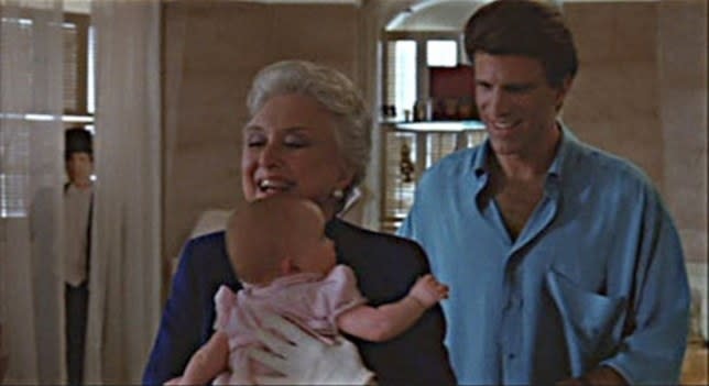 A screen shot from Three Men a Baby which features the Ted Danson cutout in the window