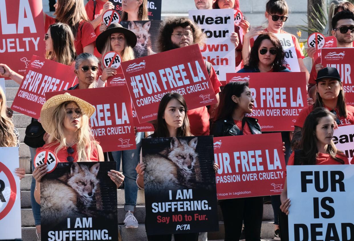 Protesters call for the ban of fur sales in front of City Hall in Los Angeles on Tuesday. (Photo: Richard Vogel/Associated Press)