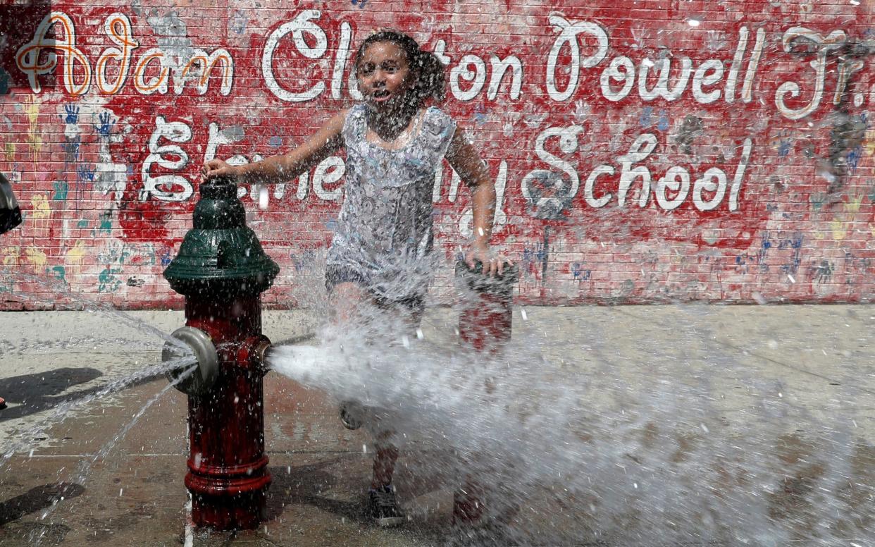A girl cools off from the heat in New York City as extreme temperatures reach the East Coast - REUTERS