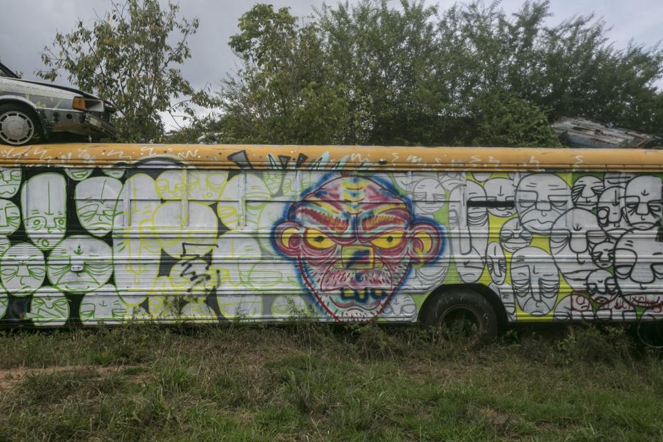 Fast forward 50 years, unwanted visitors started painting inappropriate things on the bus fence. Walter Wade, who now runs the business, called in some artists to paint over the graffiti and thus, the School Bus Graveyard was born.