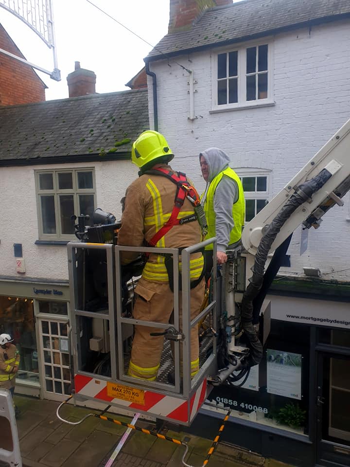 The man being rescued by a firefighter