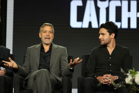 Actor, executive producer, and director George Clooney (L) and actor Christopher Abbott speak on a panel for the Hulu series "Catch-22", during the Television Critics Association (TCA) Winter Press Tour in Pasadena, California, U.S., February 11, 2019. REUTERS/Lucy Nicholson