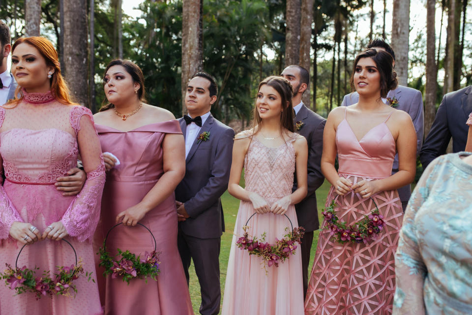 Groomsmen and bridesmaids standing outside