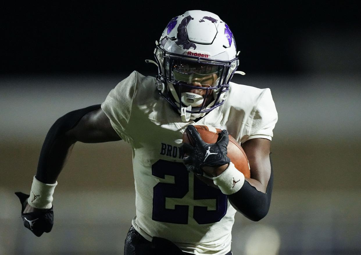 Brownsburg Bulldogs running back Garrett Sherrell (25) rushes up the field Friday, Oct. 28, 2022, at Ben Davis High School in Indianapolis. Brownsburg Bulldogs lead at the half against the Ben Davis Giants, 27-6. 