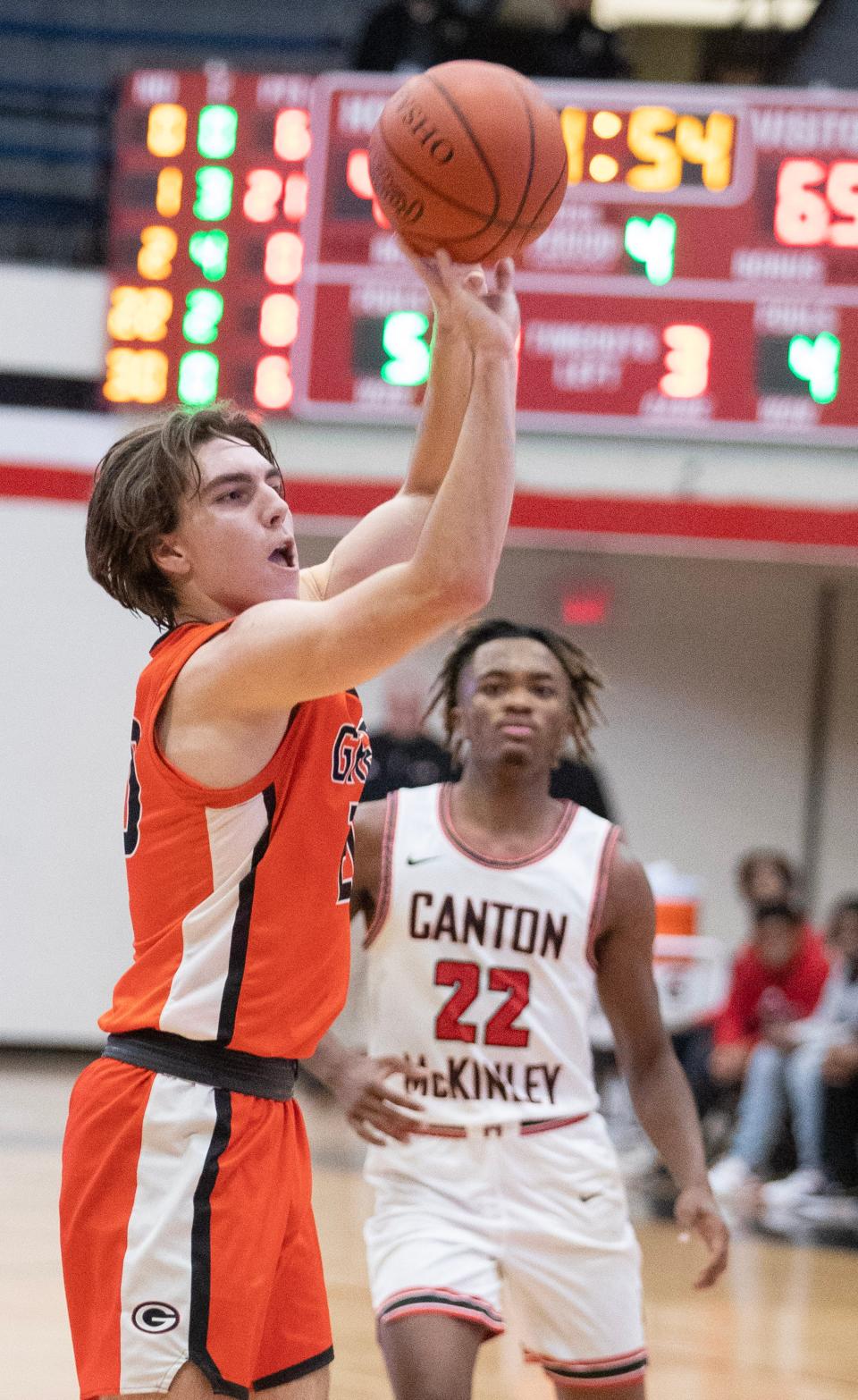 Green's Brady Rollyson lines up a shot as McKinley's Tra'Sean Foster looks on during a high school boys basketball game at Memorial Field House on Friday, Jan. 6, 2023.