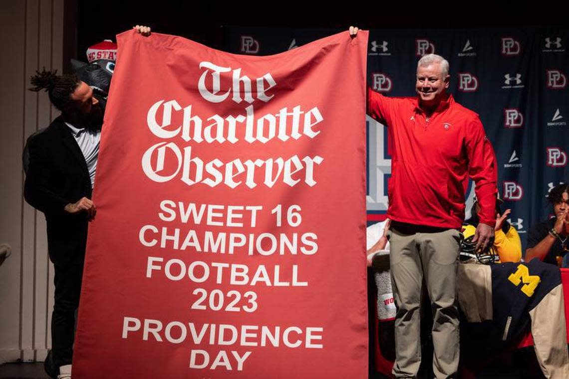 Talking Preps co-host Sam Greiner presents Providence Day coach Chad Grier with the 2023 Charlotte Observer Sweet 16 banner