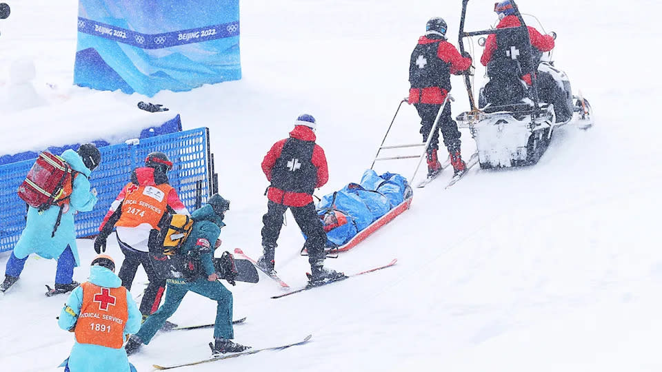 This photo shows Belle Brockhoff being taken from the mountain on a stretcher after crashing during the snowboard mixed team cross.