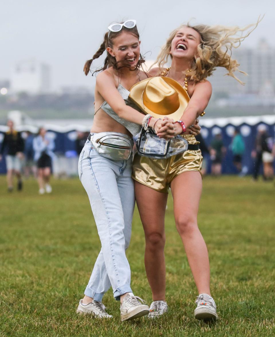 Two friends found plenty of room on the Great Lawn as a light rain shooed much of the crowd seeking shelter on first day of the 2022 Forecastle Festival Friday at Waterfront Park. May 27, 2022