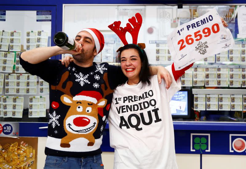 Owner Jose Maria Nogales and his wife Paloma Rodriguez celebrate selling the winning ticket of the biggest prize in Spain's Christmas lottery "El Gordo" (The Fat One) in Seville