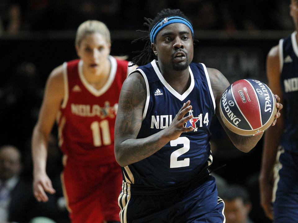 East's Wale (2) brings the ball up as West's Elena Delle Donne (11) gives chase during the first half of the NBA All-Star celebrity basketball game in New Orleans, Friday, Feb. 14, 2014. The East won 60-56. (AP Photo/Bill Haber)